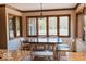 Charming dining area with large windows, a stylish light fixture, and a table with seating for four at 6712 Forrest Commons Blvd, Indianapolis, IN 46227