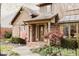 Charming brick home with a covered front entrance, landscaped yard, and an American flag at 6712 Forrest Commons Blvd, Indianapolis, IN 46227