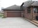 Spacious two car garage with concrete driveway and brick exterior, ample parking at 6712 Forrest Commons Blvd, Indianapolis, IN 46227