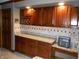Charming kitchen with granite countertops, rich wood cabinets and wine storage at 6712 Forrest Commons Blvd, Indianapolis, IN 46227