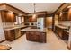 Gourmet kitchen featuring an island, stainless steel appliances, custom cabinetry, and granite countertops at 6712 Forrest Commons Blvd, Indianapolis, IN 46227