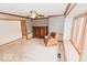 Cozy living room featuring plush carpeting, wood trim, and a ceiling fan for added comfort at 6712 Forrest Commons Blvd, Indianapolis, IN 46227