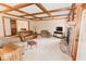 Bright living room features a brick fireplace, coffered ceilings, plush seating, and neutral colors at 6712 Forrest Commons Blvd, Indianapolis, IN 46227