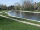 Pond view with walking path, rock lined shore and bridge at 6712 Forrest Commons Blvd, Indianapolis, IN 46227