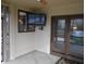 Enclosed porch features wall mounted television, ceiling fan and glass paned exterior door at 6712 Forrest Commons Blvd, Indianapolis, IN 46227