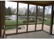 Relaxing view from the screened-in porch overlooking a tranquil pond with a fountain at 6712 Forrest Commons Blvd, Indianapolis, IN 46227