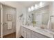 Modern bathroom features double sinks, a large mirror, and an open doorway at 6925 Sable Point Dr, Brownsburg, IN 46112