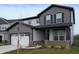 Two-story home with dark trim accents, a well manicured front lawn, and a two-car garage at 6925 Sable Point Dr, Brownsburg, IN 46112