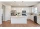 Bright kitchen features stainless steel appliances, white cabinetry, and a large center island at 6925 Sable Point Dr, Brownsburg, IN 46112