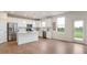 Bright kitchen featuring stainless steel appliances, white cabinets, a kitchen island and wood floors at 6925 Sable Point Dr, Brownsburg, IN 46112