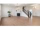 Open concept living room featuring wood floors, fire place, staircase, and lots of natural light at 6925 Sable Point Dr, Brownsburg, IN 46112