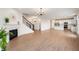Open concept floor plan featuring wood floors, fireplace, staircase, and kitchen with white cabinets at 6925 Sable Point Dr, Brownsburg, IN 46112