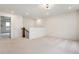 Open loft area with neutral carpeting, adjacent to a doorway and a staircase at 6925 Sable Point Dr, Brownsburg, IN 46112