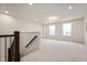 Spacious loft area with neutral carpeting and natural light from two windows at 6925 Sable Point Dr, Brownsburg, IN 46112