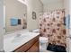 Bathroom with a single sink vanity, a mirror, a shower with curtain and beige wall paint at 7574 Merrick Dr, Brownsburg, IN 46112