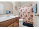 Bright bathroom featuring a single sink vanity, a shower with a curtain, and tile flooring at 7574 Merrick Dr, Brownsburg, IN 46112