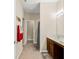 Bright bathroom features a single vanity, tiled flooring, and a doorway to the hallway at 7574 Merrick Dr, Brownsburg, IN 46112