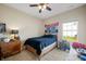 Bedroom featuring carpet flooring, a wood bed frame, and simple neutral decor at 7574 Merrick Dr, Brownsburg, IN 46112