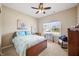 Comfortable bedroom with a ceiling fan, a large window, and carpet flooring at 7574 Merrick Dr, Brownsburg, IN 46112