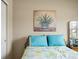 A close up of a bed in a bedroom featuring an art piece above the headboard at 7574 Merrick Dr, Brownsburg, IN 46112