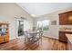 Bright breakfast nook featuring hardwood floors, a modern light fixture, and sliding glass doors to the backyard at 7574 Merrick Dr, Brownsburg, IN 46112