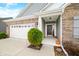 Close-up of the home's entrance highlighting the brick facade, dark front door, and neat landscaping around the porch at 7574 Merrick Dr, Brownsburg, IN 46112