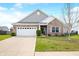 Charming single-Gathering home showcasing a well-manicured lawn, attached two-car garage, and tasteful brick and gray siding at 7574 Merrick Dr, Brownsburg, IN 46112