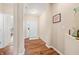 Bright hallway with modern flooring, leading to the main entrance and living areas, accented by decorative elements at 7574 Merrick Dr, Brownsburg, IN 46112
