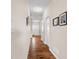 Extended view of the hallway, showing continuous flooring, neutral wall colors, and framed pictures enhancing the space at 7574 Merrick Dr, Brownsburg, IN 46112