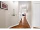 Bright hallway featuring wood-look flooring, neutral paint, and decorative wall art leading into the home's living spaces at 7574 Merrick Dr, Brownsburg, IN 46112
