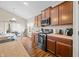 Kitchen boasts stainless steel appliances, wood cabinetry, and breakfast bar at 7574 Merrick Dr, Brownsburg, IN 46112