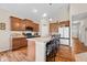 Kitchen features wood cabinets, stainless steel appliances, bar seating, and pendant lighting at 7574 Merrick Dr, Brownsburg, IN 46112