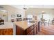 Open-concept kitchen with island and view to living and dining area at 7574 Merrick Dr, Brownsburg, IN 46112