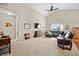 Spacious living room with vaulted ceiling, ceiling fan, neutral carpet, and comfortable leather furniture at 7574 Merrick Dr, Brownsburg, IN 46112