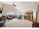 Open layout shows the living room, kitchen, and dining area with hardwood and neutral carpet floors at 7574 Merrick Dr, Brownsburg, IN 46112