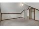 Bright attic room with wood trim, neutral carpet, and an adjoining bonus room at 7609 Camby Rd, Indianapolis, IN 46113