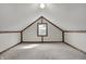 Attic features carpet, rustic wood trim, and natural light from the window at 7609 Camby Rd, Indianapolis, IN 46113