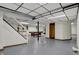 The basement features a billiards area, bar, paneled ceiling with recessed lighting, gray floor, and wooden shelving at 7609 Camby Rd, Indianapolis, IN 46113