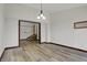 Dining room with wood floors and an open staircase nearby at 7609 Camby Rd, Indianapolis, IN 46113