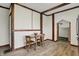 Charming dining area featuring light wood floors and rustic wood beam accents at 7609 Camby Rd, Indianapolis, IN 46113