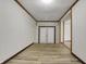 Long hallway features light wood floors and white doors to the backyard at 7609 Camby Rd, Indianapolis, IN 46113