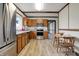 Well-lit kitchen features stainless appliances, wood cabinets, and adjacent dining area at 7609 Camby Rd, Indianapolis, IN 46113