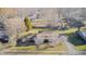A bird's-eye view of a home with a well-kept lawn, surrounded by mature trees in a residential neighborhood at 920 Mellowood Dr, Indianapolis, IN 46217