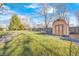 A charming backyard featuring a storage shed with a decorative horseshoe and a well-maintained lawn at 920 Mellowood Dr, Indianapolis, IN 46217