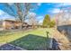 Expansive backyard featuring lush grass, mature trees, and a charming fence, perfect for outdoor activities at 920 Mellowood Dr, Indianapolis, IN 46217