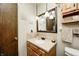 Well-lit bathroom with a single sink, decorative mirror, and neutral wall art at 920 Mellowood Dr, Indianapolis, IN 46217