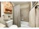 Neutral bathroom features a shower over tub with complementing tiling and vanity storage at 920 Mellowood Dr, Indianapolis, IN 46217