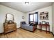 Bright bedroom with wood flooring, black and white bedding, and dresser with mirror at 920 Mellowood Dr, Indianapolis, IN 46217