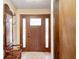 Inviting entryway featuring a solid wood front door and an antique coat rack with mirror at 920 Mellowood Dr, Indianapolis, IN 46217