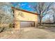 A spacious two-car garage showcasing a brick and siding exterior, complemented by a paved driveway at 920 Mellowood Dr, Indianapolis, IN 46217